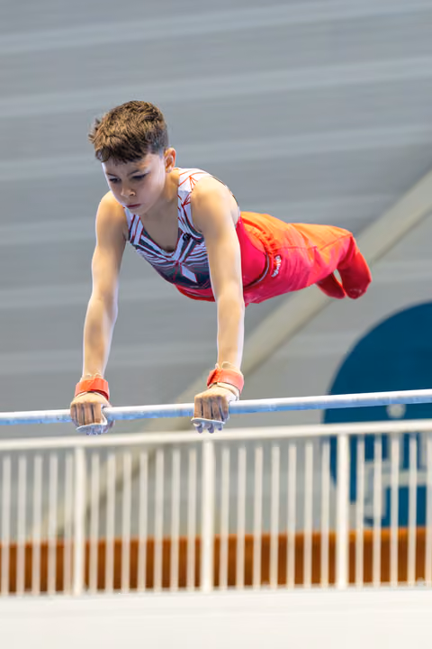 Young athlete holds a horizontal position on the bar, demonstrating strength and concentration during outdoor training